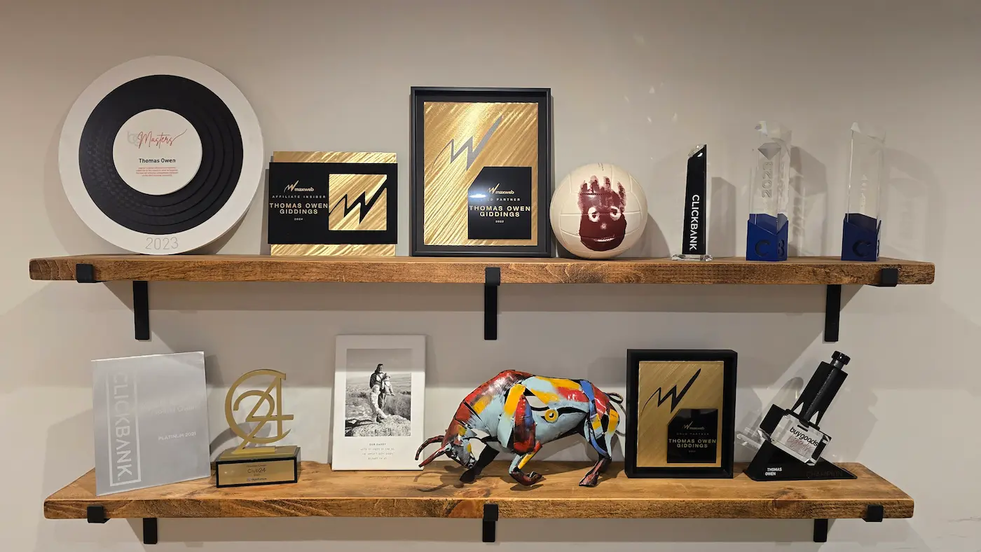 Thomas's affiliate awards shelf: ClickBank Diamond, MaxWeb Gold Partner, BuyGoods.