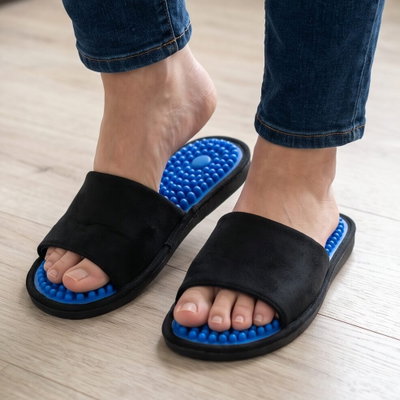 Black slides with blue massage nubs, worn